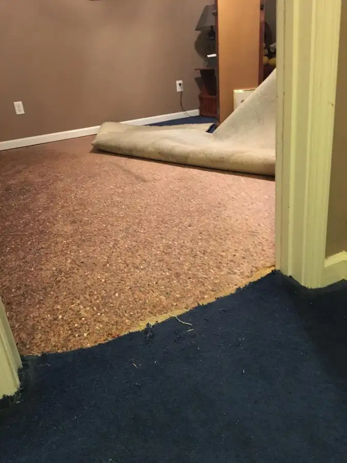 Carpet pad removal revealing water damage during Drying & Dehumidification in Junction City
